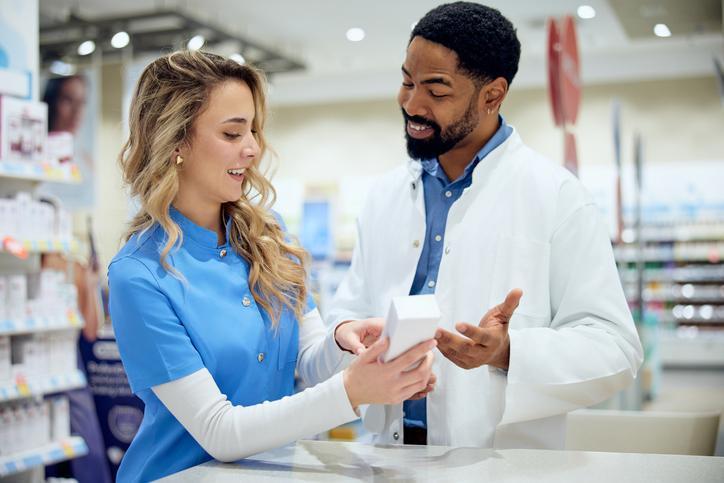 A pharmacy technician assisting a pharmacist in a community pharmacy