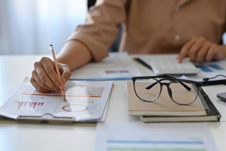 An accounting student reviewing financial records and identifying common accounting mistakes