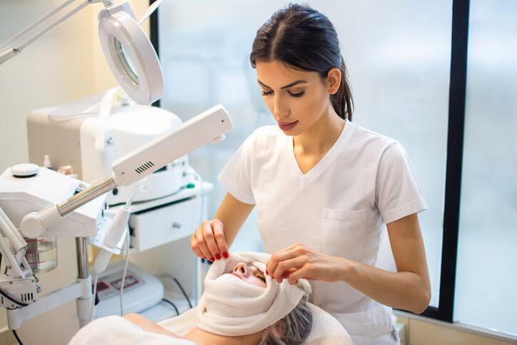 A medical esthetician student practicing skincare techniques
