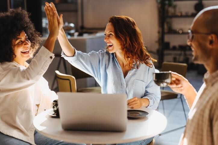 A business management training grad working in a team