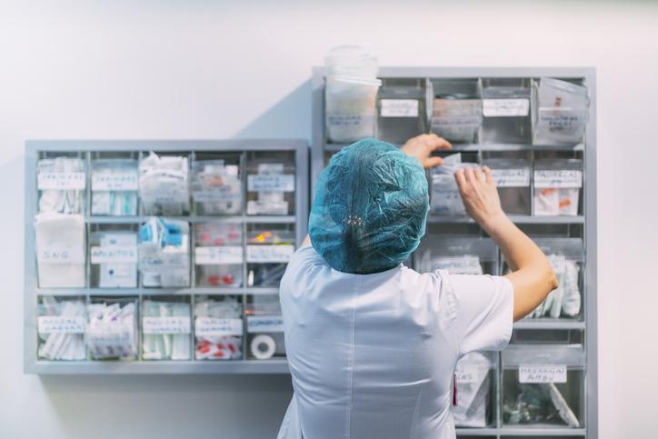 A pharmacy technician organizing medications in a long-term care facility