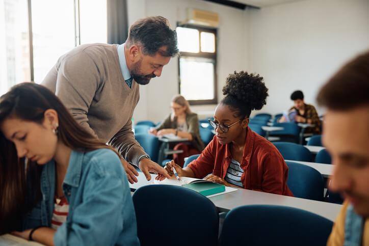 An instructor supporting a student in a classroom at our Career college in Ontario