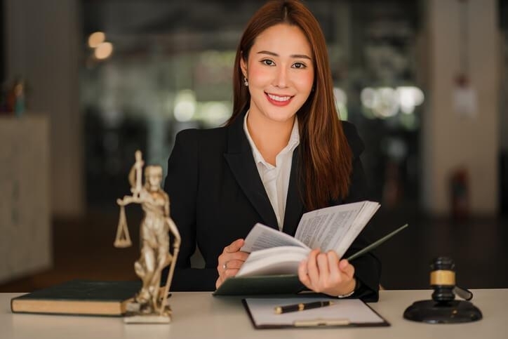 A smiling female law clerk in an office after completing her law clerk program