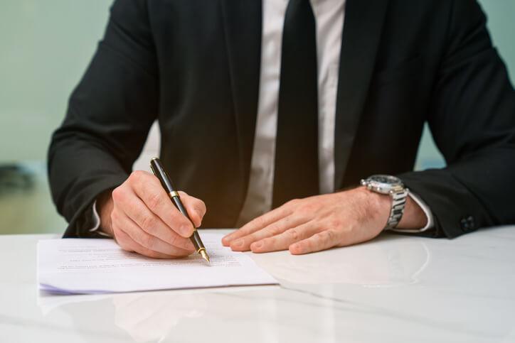 A law clerk training grad handwriting a legal document
