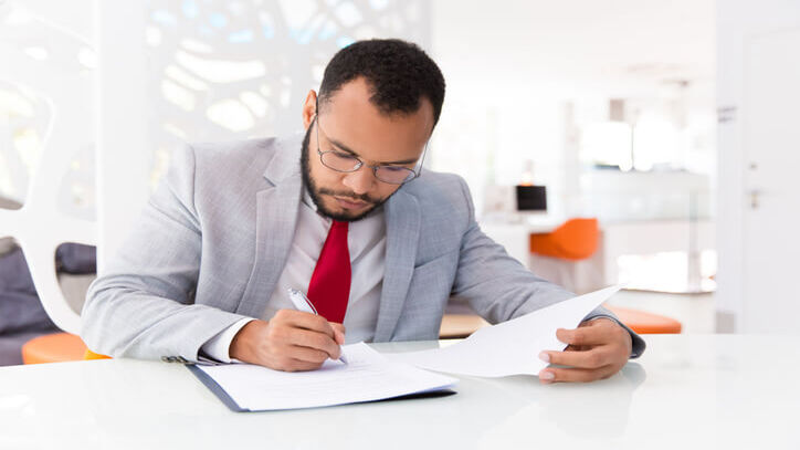 Focused male paralegal working in an office after completing his paralegal training