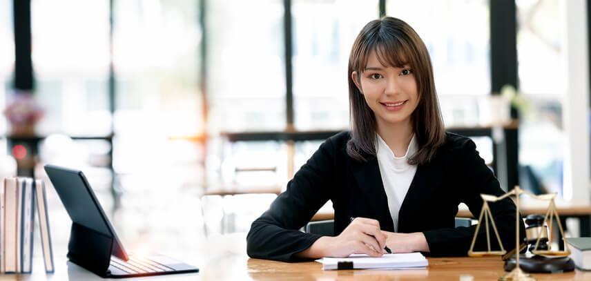 A female law clerk writing a legal document in an office