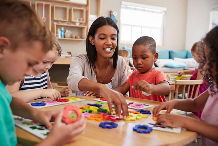 early childcare assistant leading educational activity