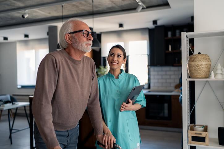 A personal support worker helping a resident in a long-term care setting A personal support worker helping a resident in a long-term care setting