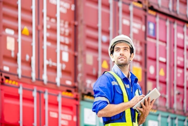 A supply chain and logistics training graduate working on a tablet