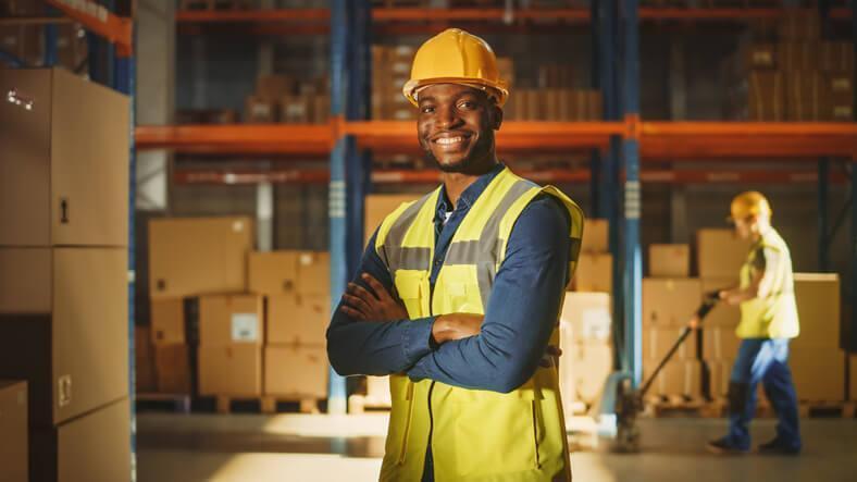 A male supply chain professional is a warehouse after logistics and supply chain management training.