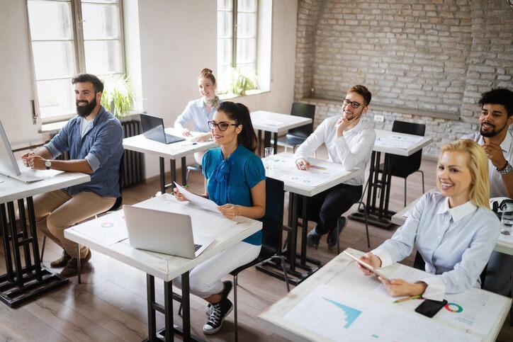 A class of business students learning analytics and reporting skills in a classroom