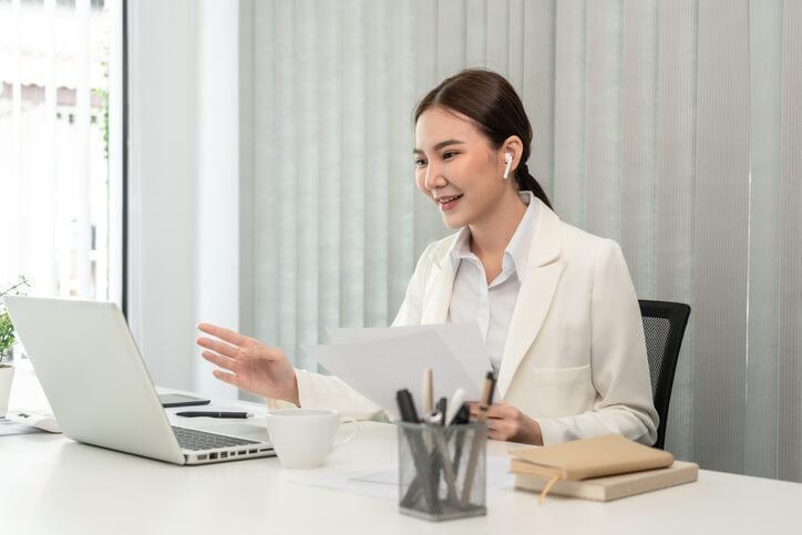 A smiling female law clerk carrying out legal research online after her law clerk training