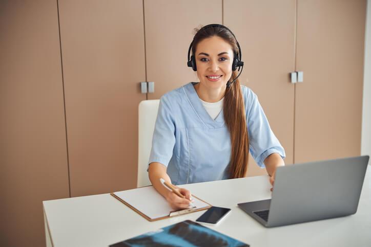 A Medical office assistant provides telehealth support during a virtual patient appointment