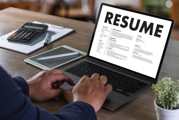 A supply chain and logistics training grad writing a CV on a laptop